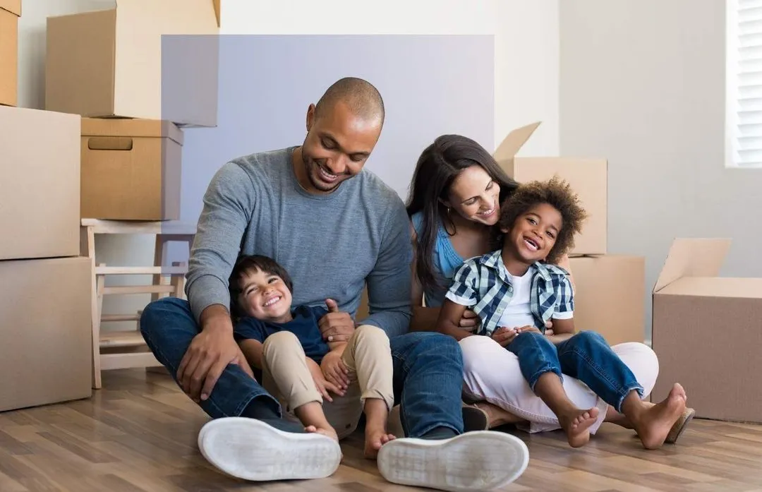 Happy family sitting on floor after movie to new home
