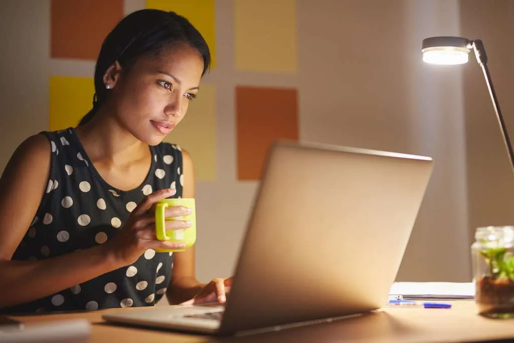 Women on computer while drinking coffee