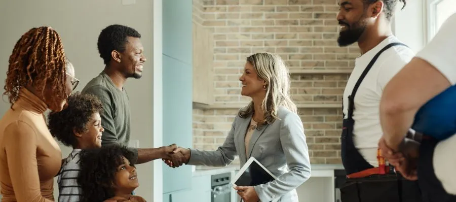 Happy women shaking hands with a man