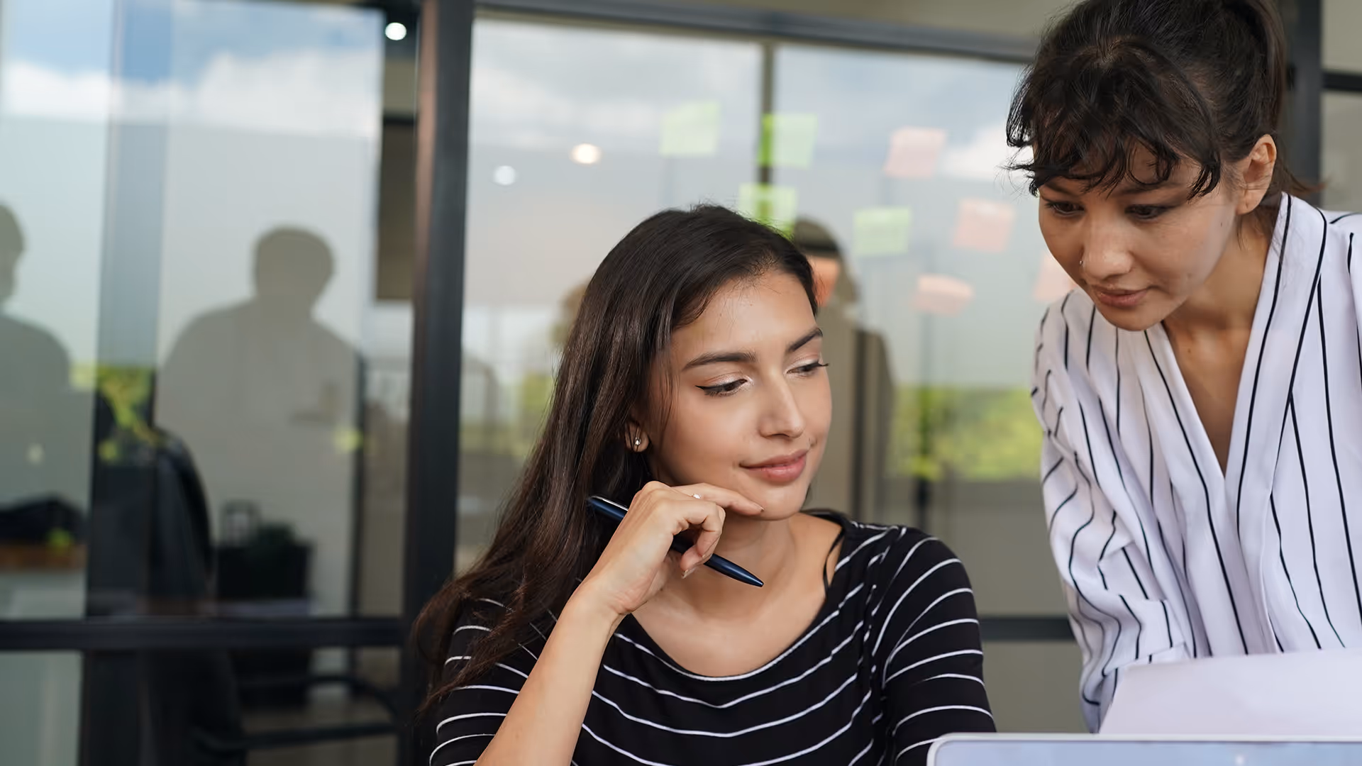 Woman in polka dot shirt smiling after receiving new job.