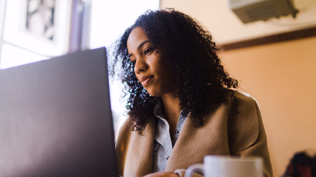 Person working thoughtfully at a desk