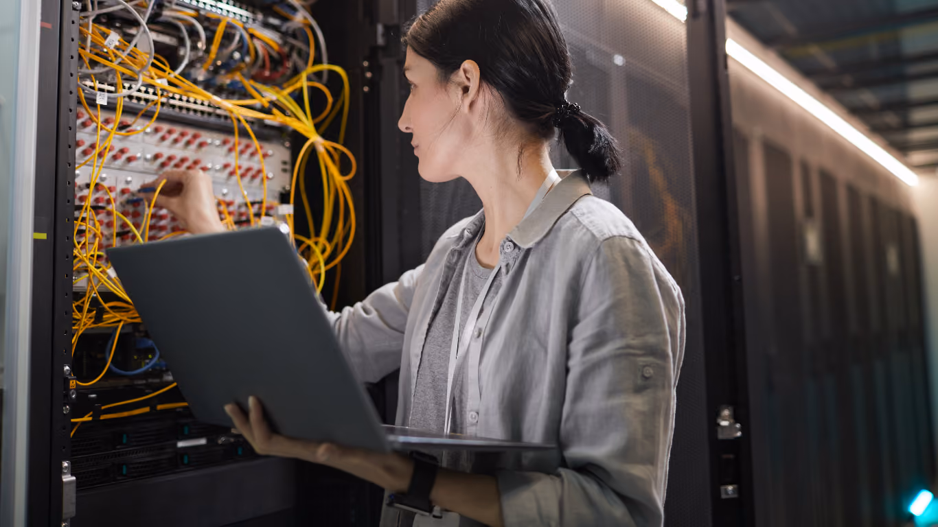Technician reviewing server equipment