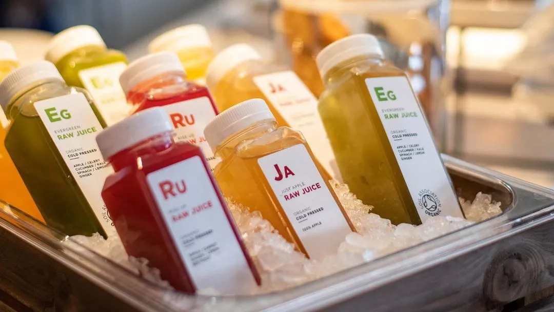 raw juice bottles in a bucket of ice