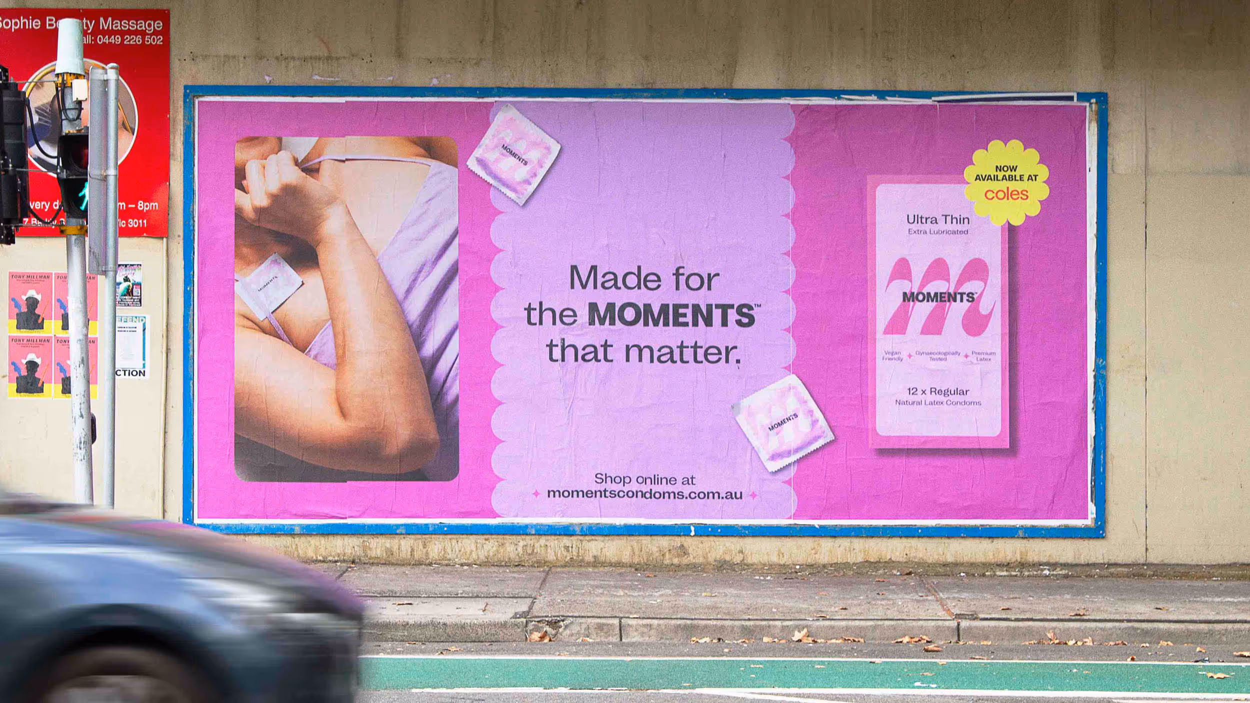 Street poster advertisement for Moments Ultra Thin natural latex condoms, showing packaged condoms and the text 'Made for the MOMENTS that matter.'