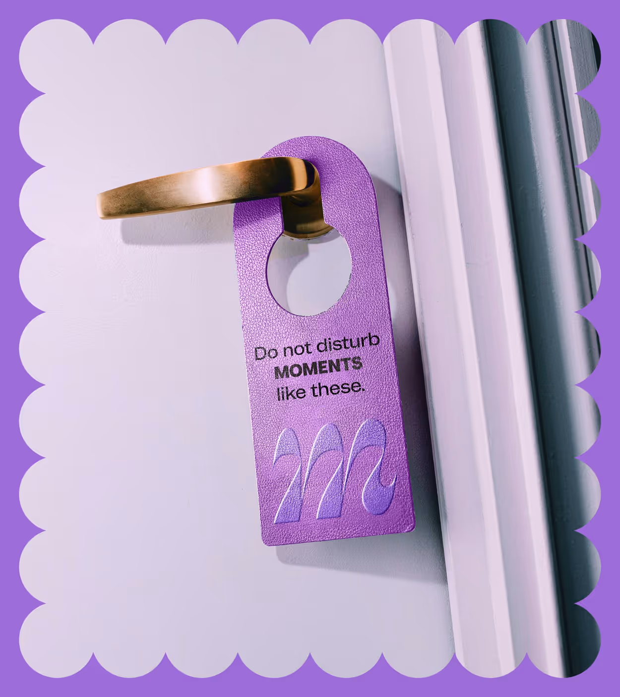 Purple door hanger on a brass door handle with text 'Do not disturb MOMENTS like these.'