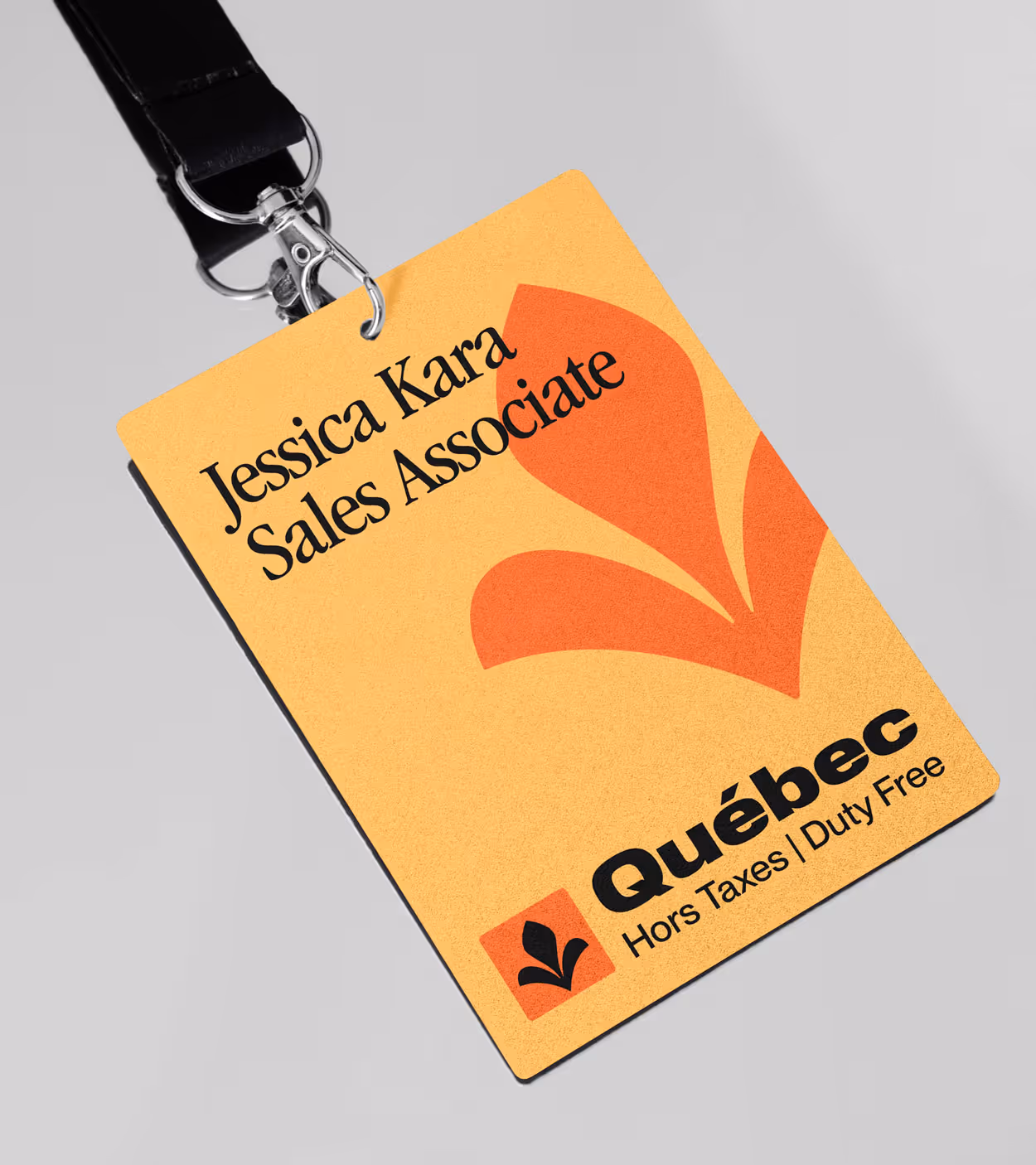 ID badge with black lanyard displaying name Jessica Kara, Sales Associate, with Québec Duty Free logo.