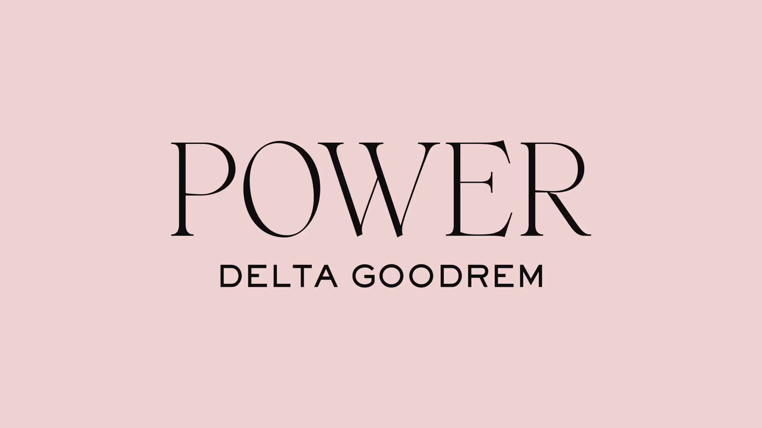 Text reading 'POWER' with 'DELTA GOODREM' written below on a light pink background.