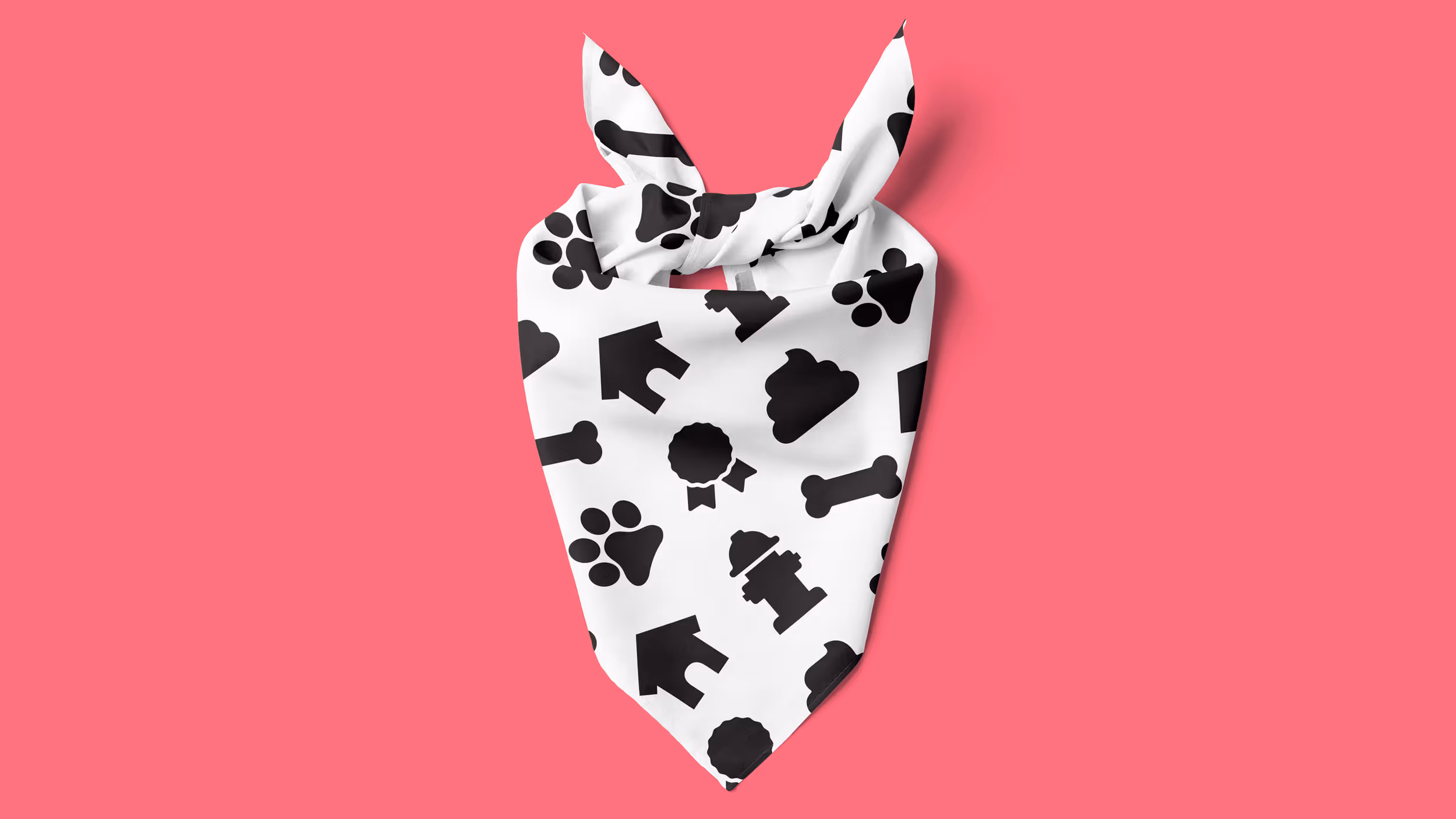 White dog bandana with black icons including paw prints, dog houses, fire hydrants, bones, clouds, and award ribbons on a pink background.