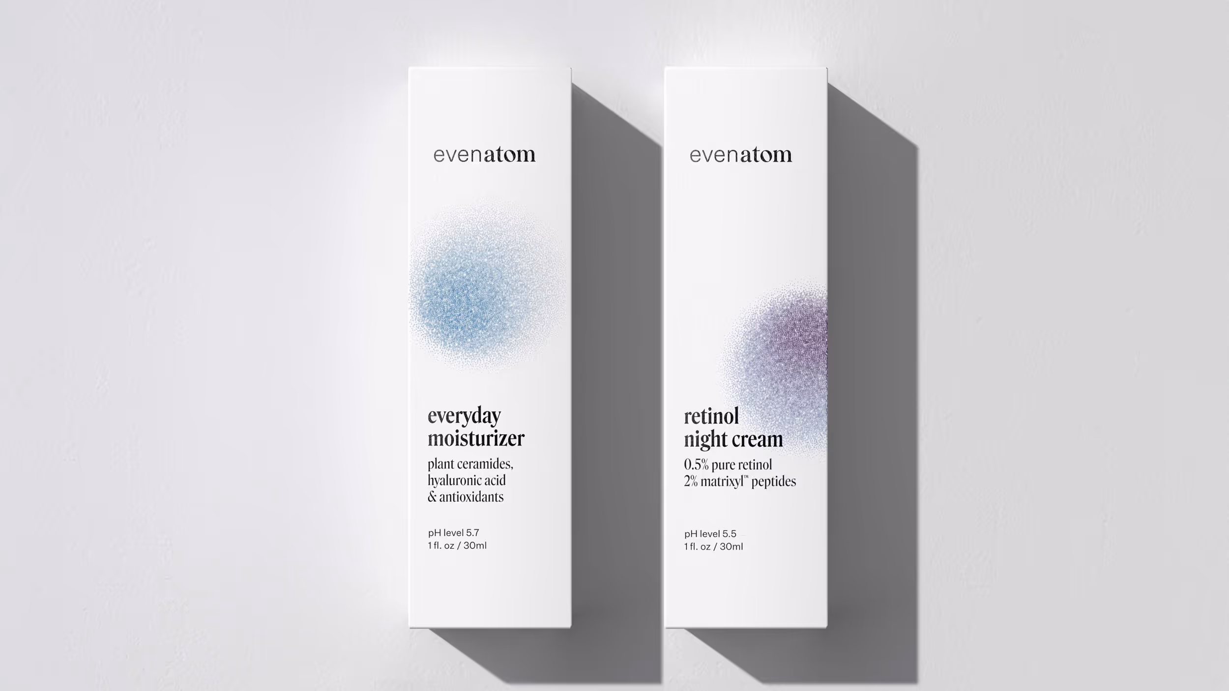 Two white Even Atom skincare product boxes side by side: everyday moisturizer with blue design, retinol night cream with purple design.
