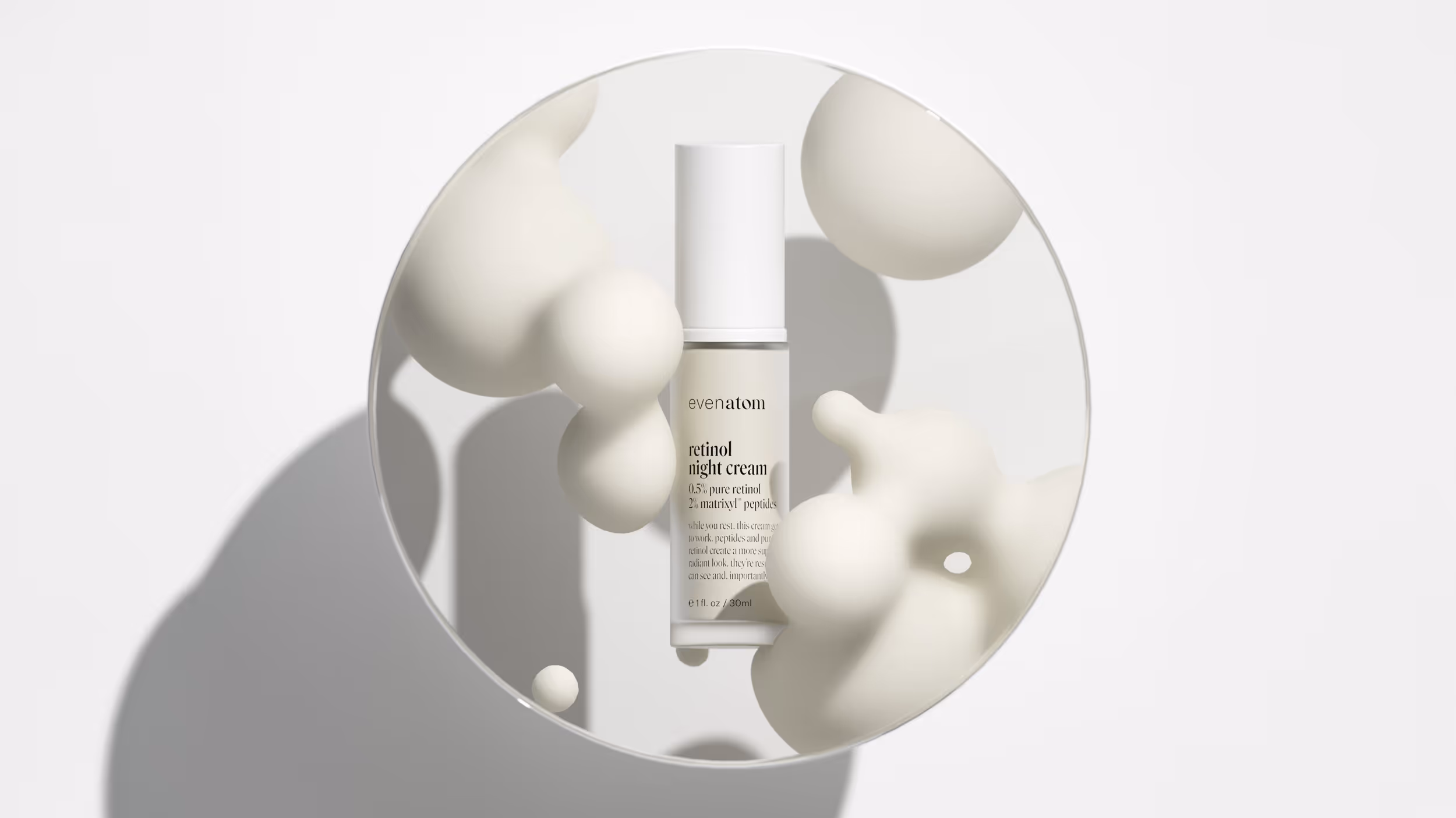 Bottle of Evenatom retinol night cream reflected in a circular mirror with abstract beige foam shapes surrounding it.