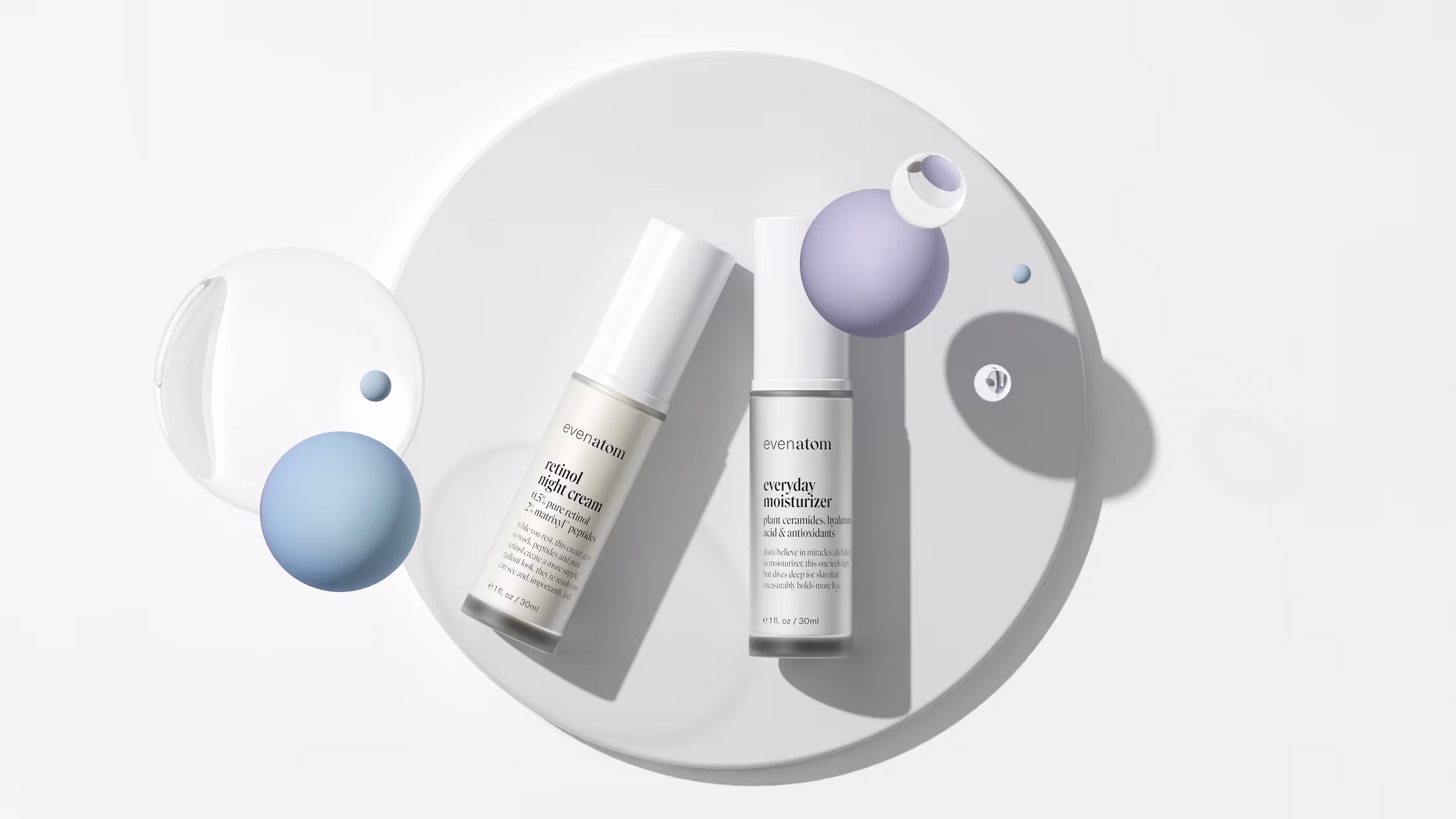 Two skincare bottles labeled 'retinol night cream' and 'everyday moisturizer' on a round white tray with floating blue and purple spheres.