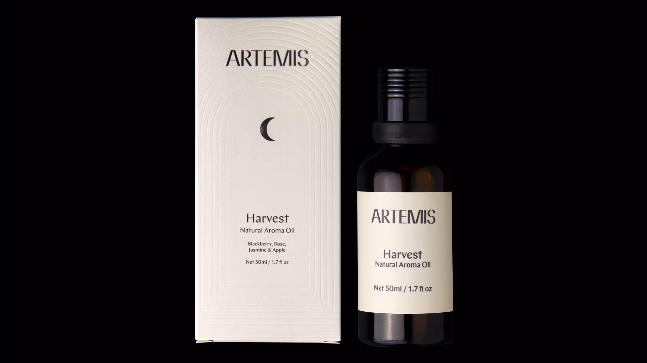 Dark amber glass bottle and white box of ARTEMIS Harvest Natural Aroma Oil, 50ml, with notes of blackberry, rose, jasmine, and apple.