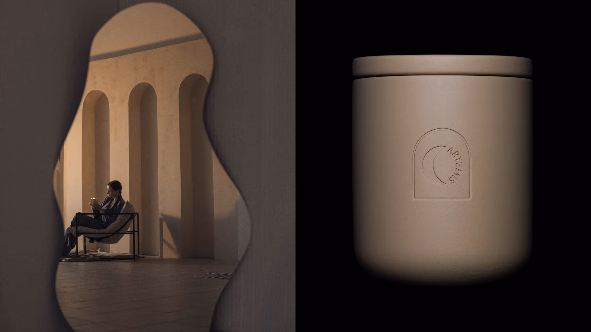 Beige Artemis scented candle in a ceramic holder shown against a black background next to a reflection of a person holding a lit candle while seated in a chair by arched columns.