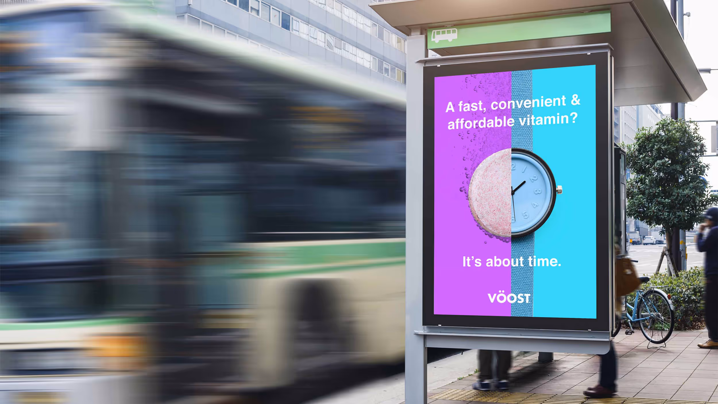 Bus stop advertisement showing a tablet split with a dissolving effervescent pill on the left and a watch face on the right, with the text 'A fast, convenient & affordable vitamin? It’s about time.' and the brand name VÖOST.