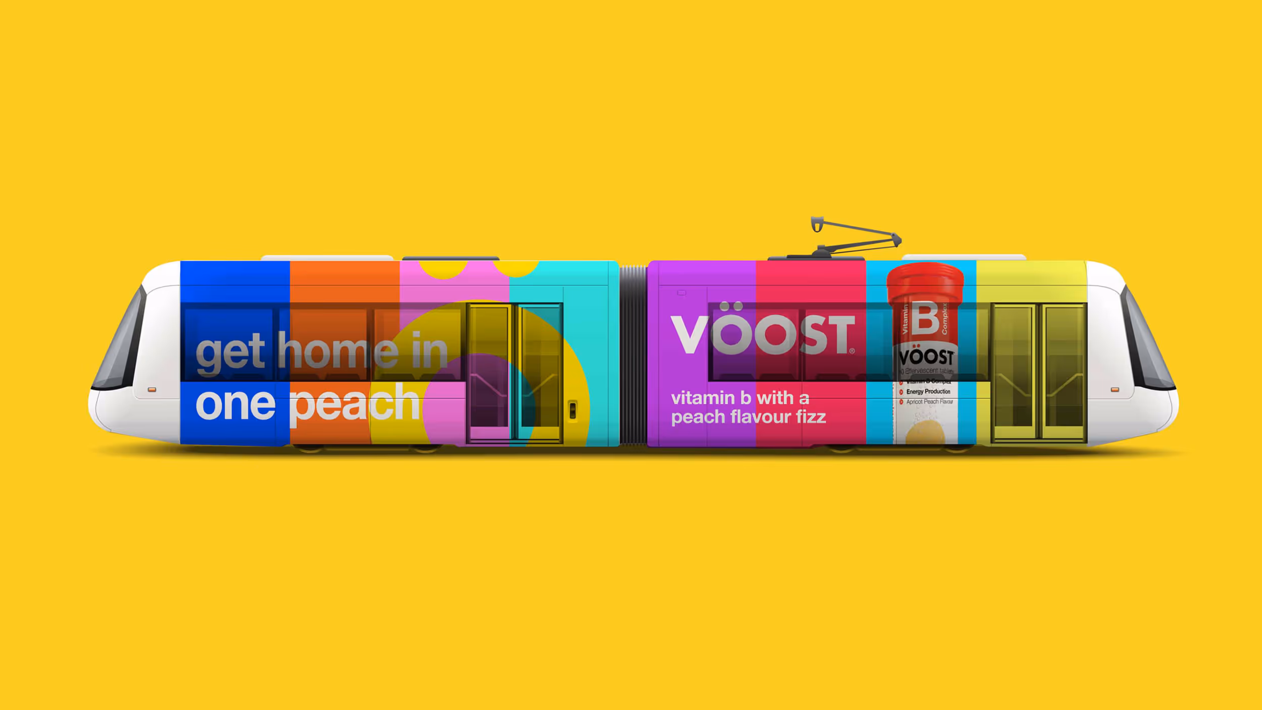 Side view of a modern tram wrapped in colorful advertisement for VOOST vitamin B peach flavor fizzy tablets.