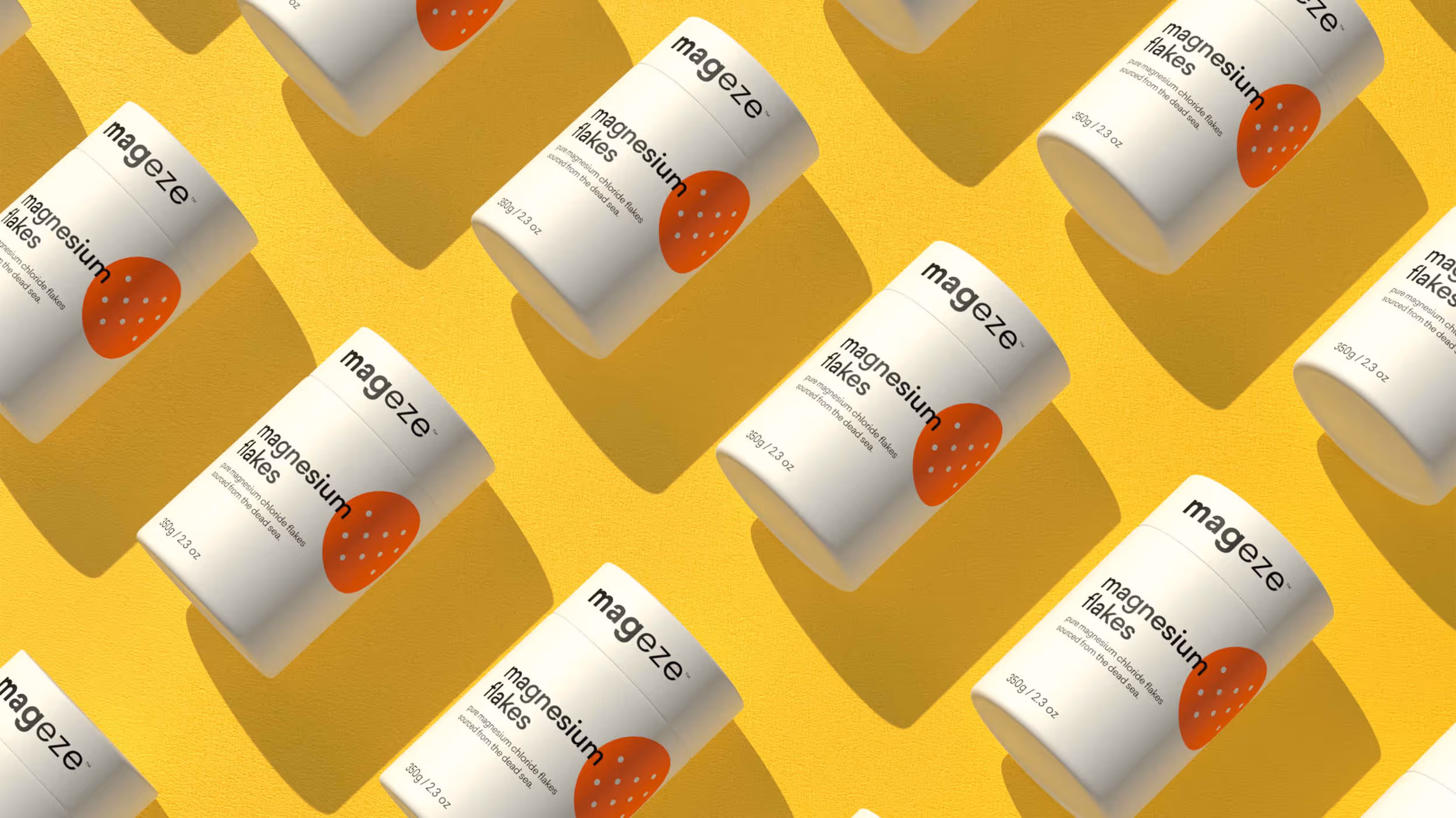 Multiple white containers of Mageze magnesium flakes with orange dot design arranged diagonally on a yellow background.
