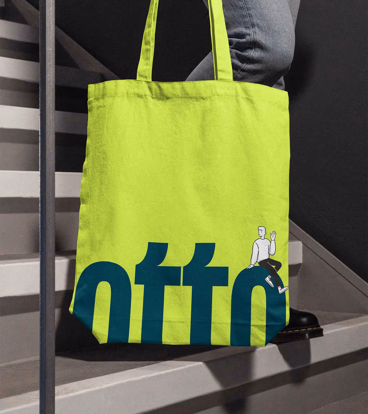 Neon yellow tote bag with large dark blue lowercase text 'otto' and illustration of a person sitting on the letter 'o'.