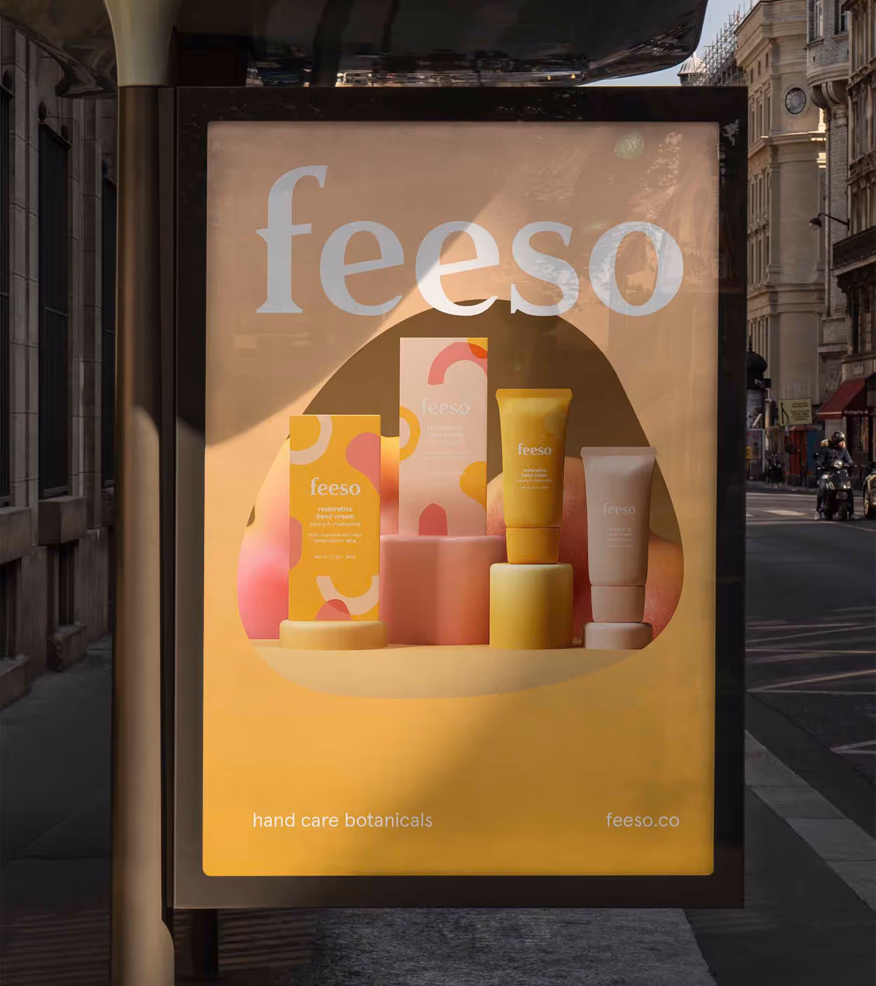Bus stop advertisement for Feeso hand care botanicals featuring restorative and rehydrating hand cream tubes and boxes in yellow and white packaging.