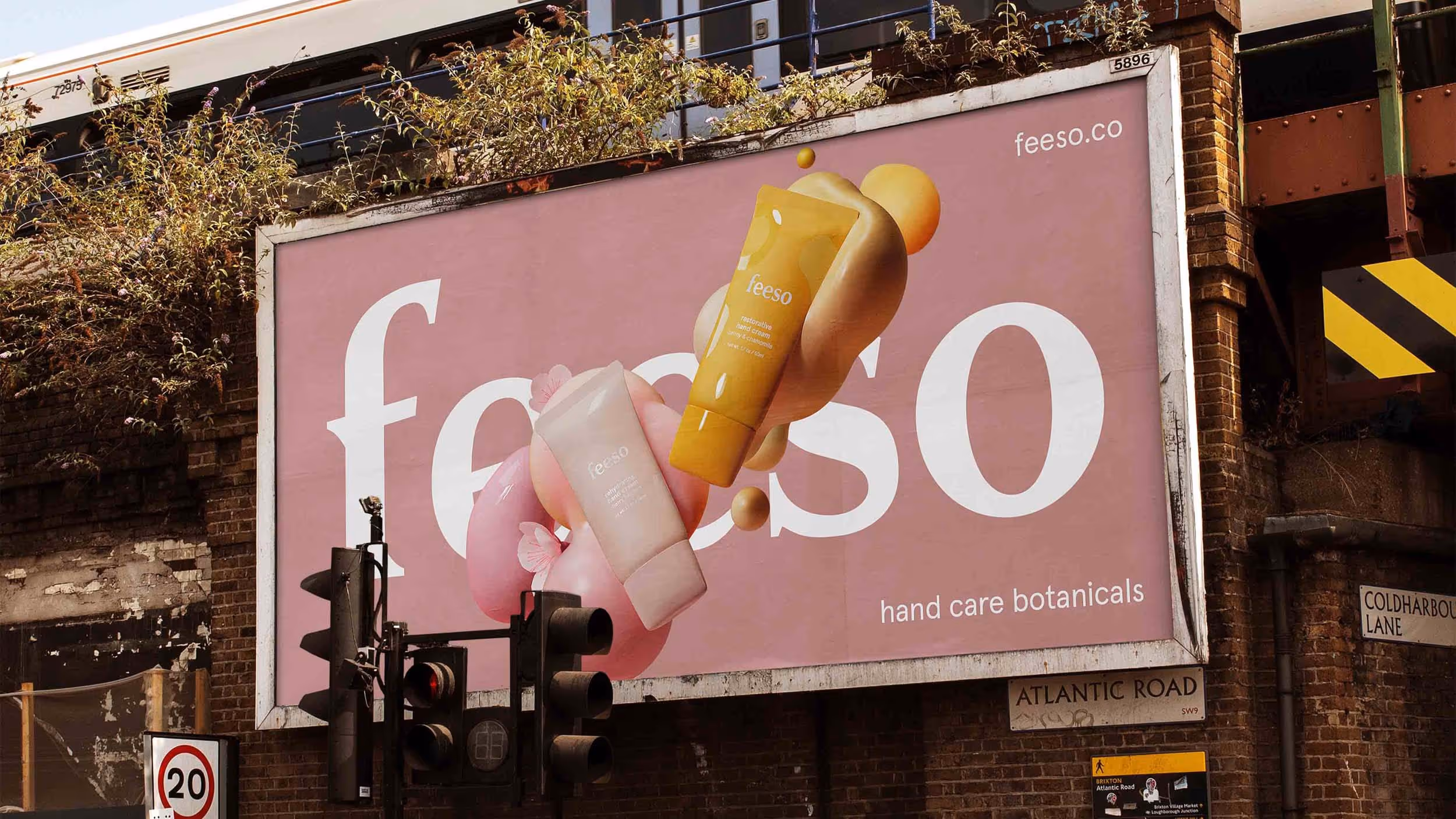 Billboard advertisement for Feeso hand care botanicals featuring two hand cream tubes, one pink and one yellow, against a pink background with large white text.
