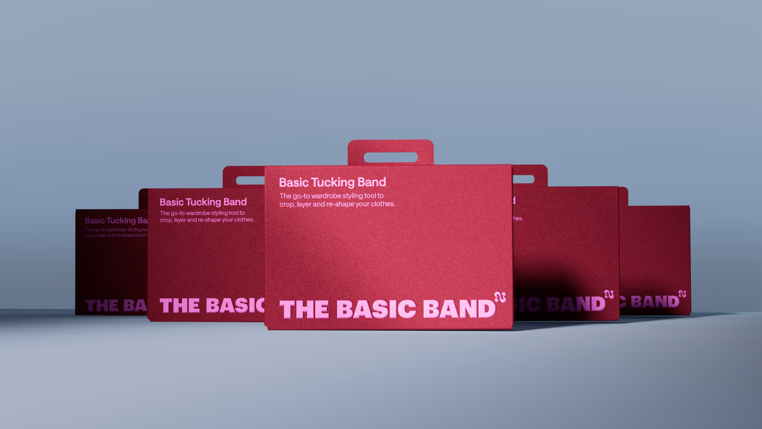 Five staggered red boxes with handles labeled 'Basic Tucking Band' and description about wardrobe styling tool.
