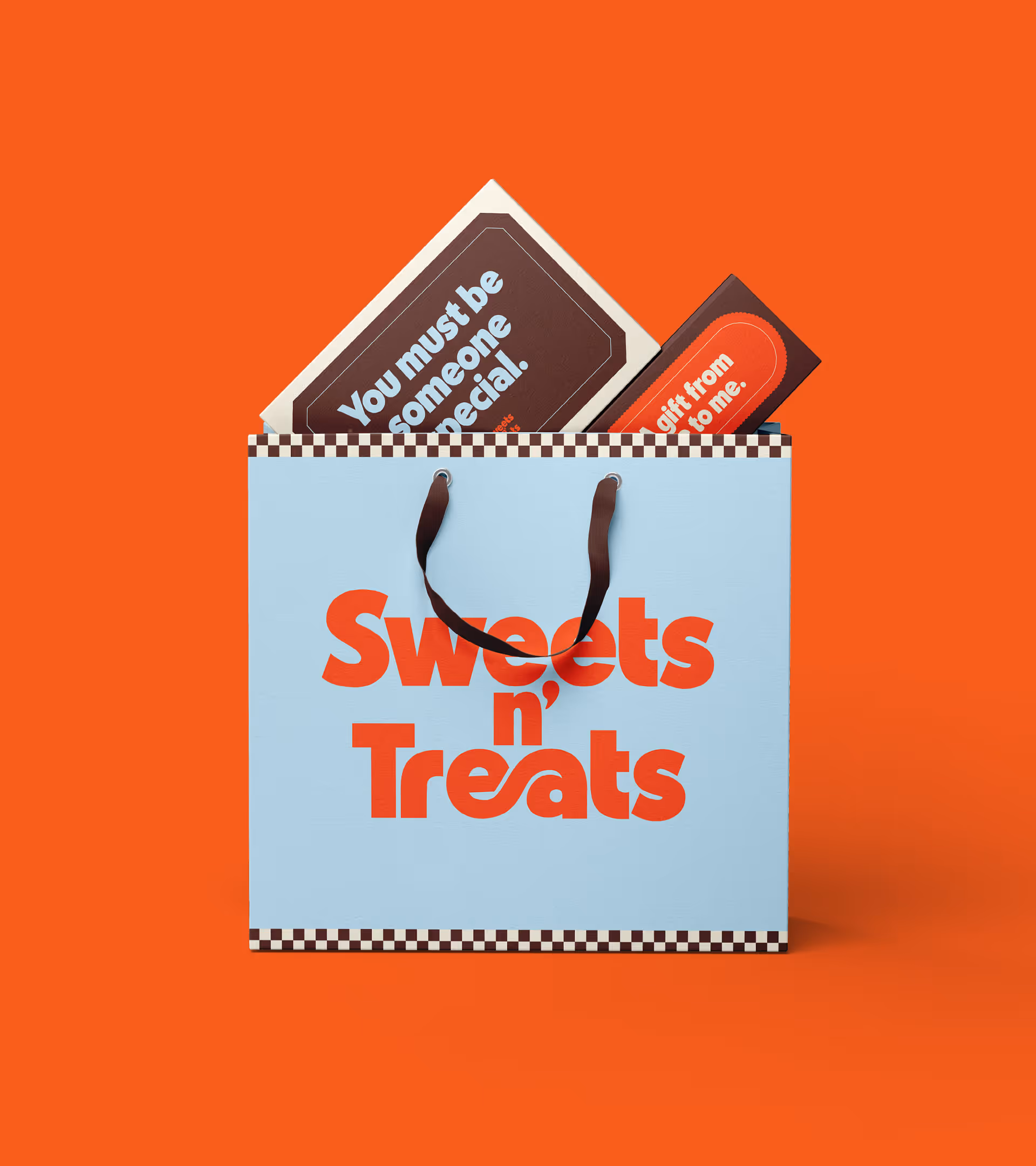 Light blue gift bag with brown handles and 'Sweets n’ Treats' in bold orange text on an orange background, containing two cards that say 'You must be someone special.' and 'gift from to me.'