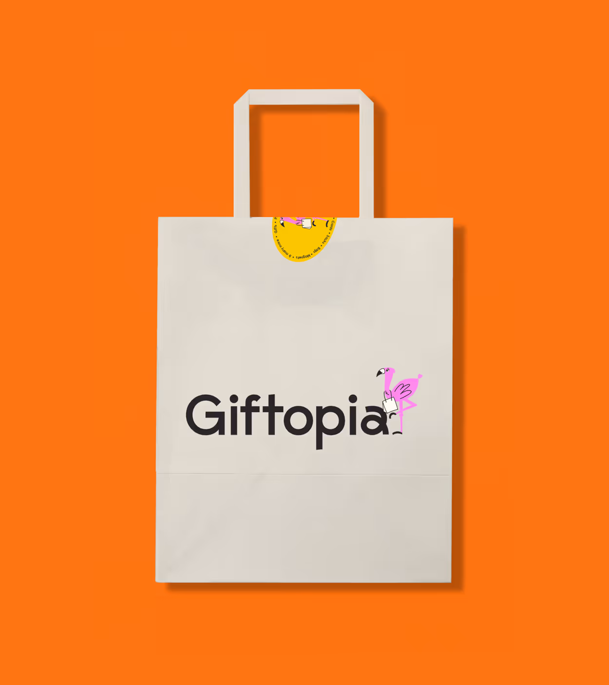 White Giftopia shopping bag with a pink flamingo illustration holding a small shopping bag, against an orange background.