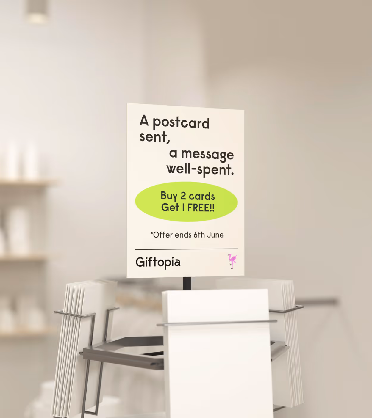 Sign on postcard rack advertising buy 2 cards get 1 free offer ending June 6 at Giftopia.