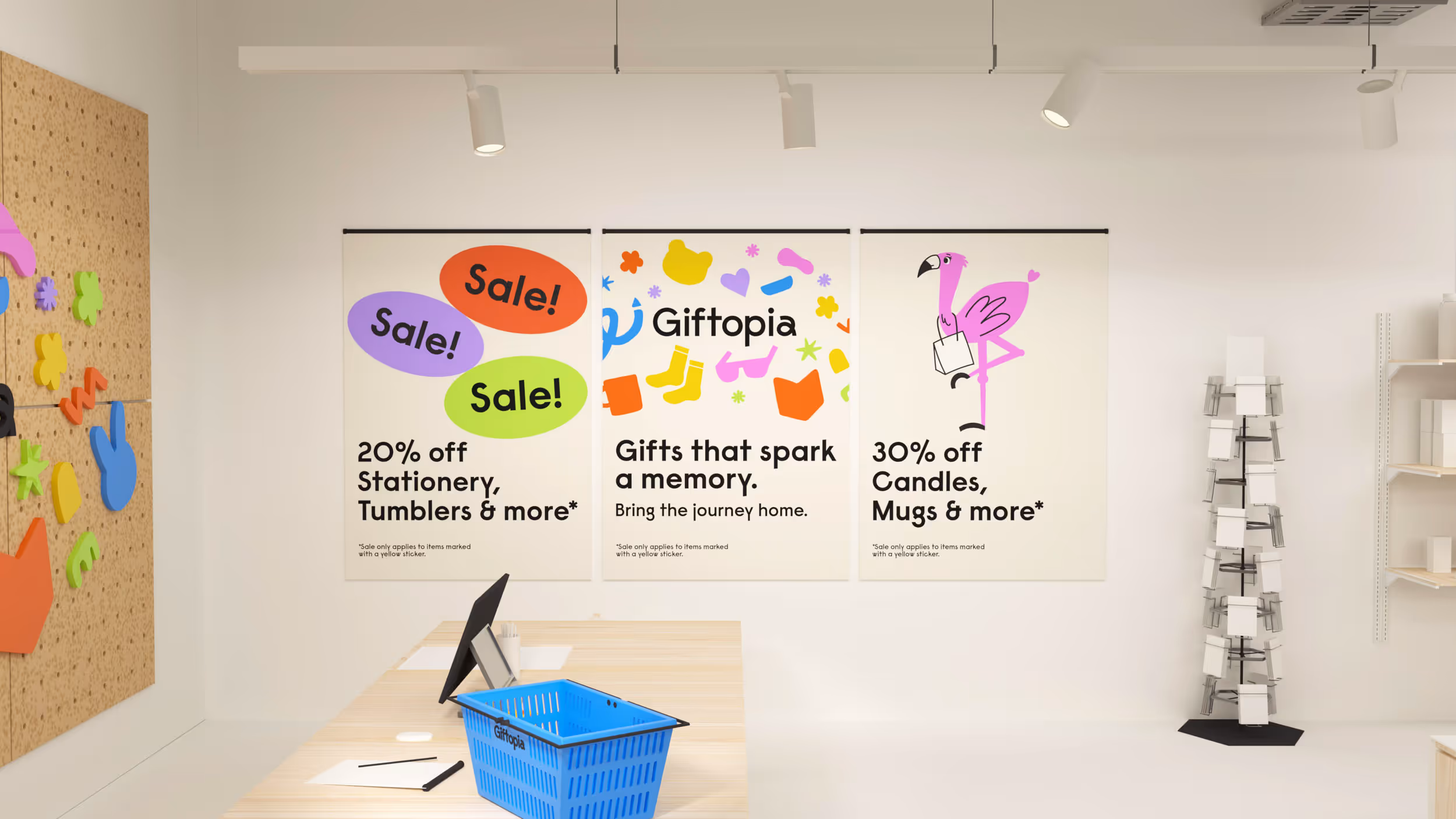 Interior of a gift shop with three promotional posters: 20% off stationery and tumblers, Giftopia branding with colorful icons, and 30% off candles and mugs, alongside a blue shopping basket on a wooden counter.