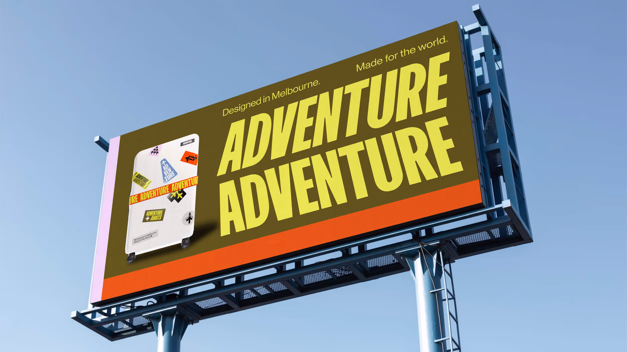 Billboard with a white suitcase featuring travel stickers and large yellow text reading 'ADVENTURE ADVENTURE', with smaller text saying 'Designed in Melbourne. Made for the world.'
