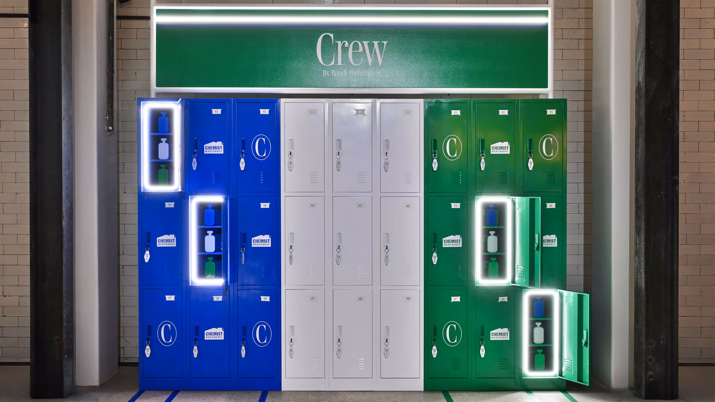 Rows of blue, white, and green lockers with 'Crew' sign above and some locker doors open showing bottles inside.