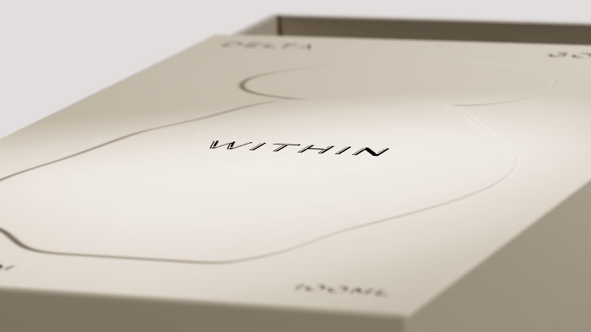 Close-up of minimalist packaging with the word 'WITHIN' printed in black on a cream-colored surface.