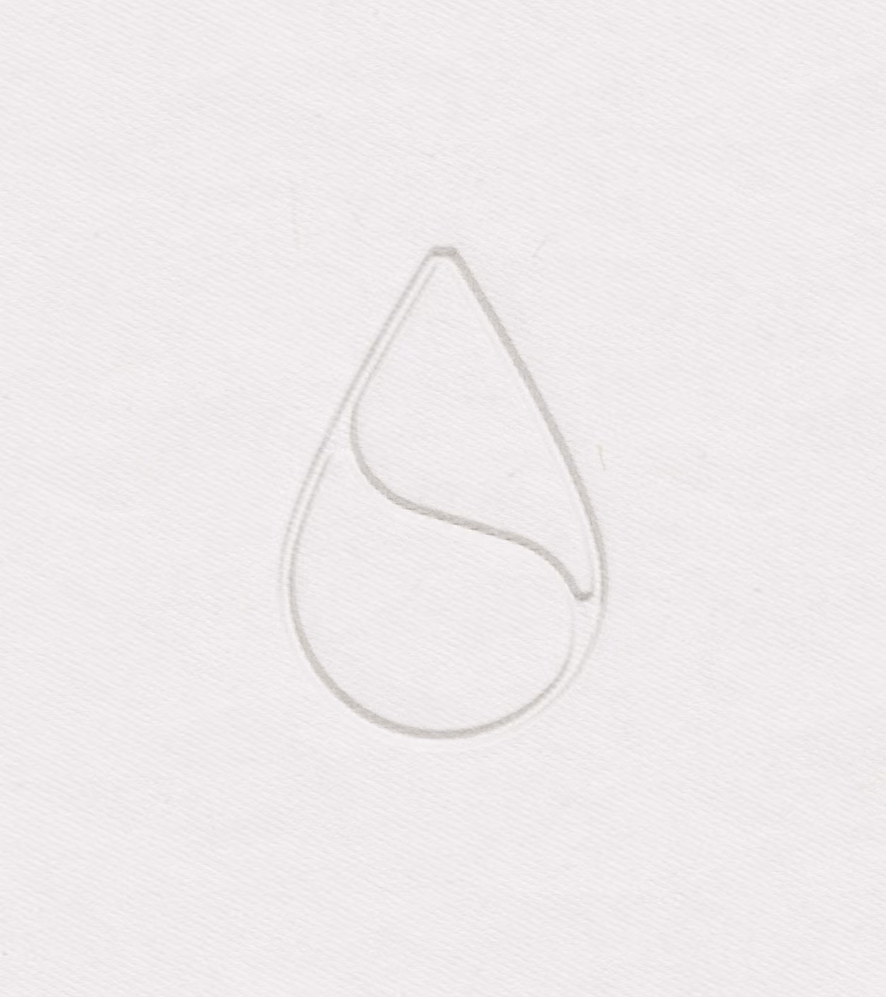 Embossed minimalist water droplet shape with a curved line inside on white textured paper.