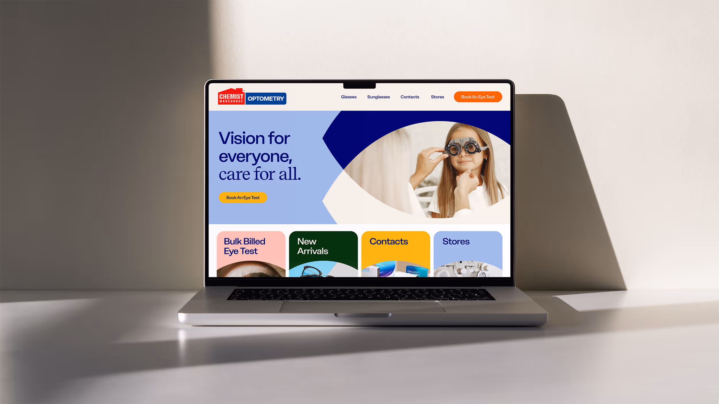 Laptop displaying Chemist Warehouse Optometry website homepage with a banner reading 'Vision for everyone, care for all' and navigation menu links.