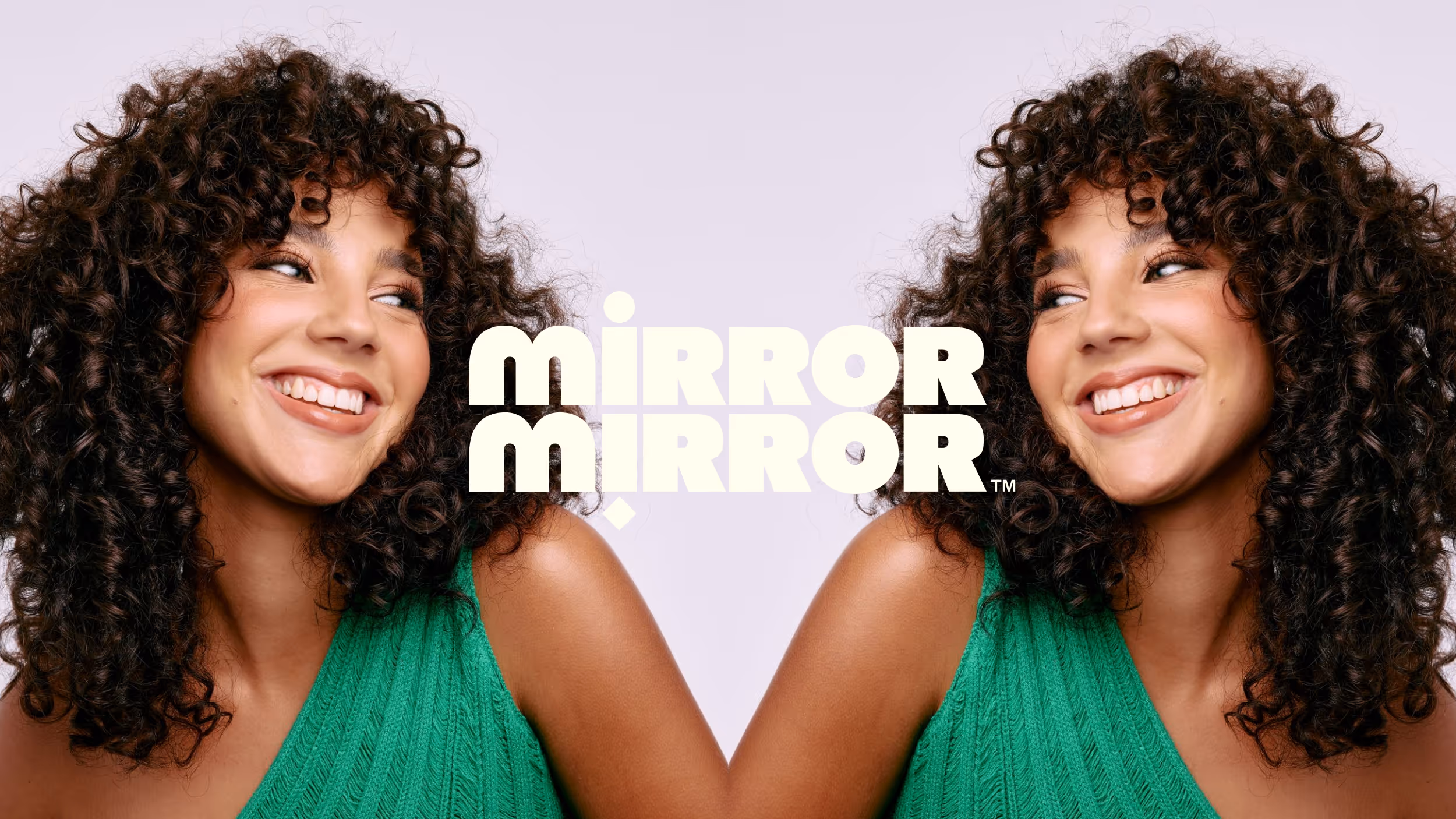 Smiling woman with curly hair wearing a green sleeveless top is mirrored on a light background with the text 'MIRROR MIRROR' in the center.