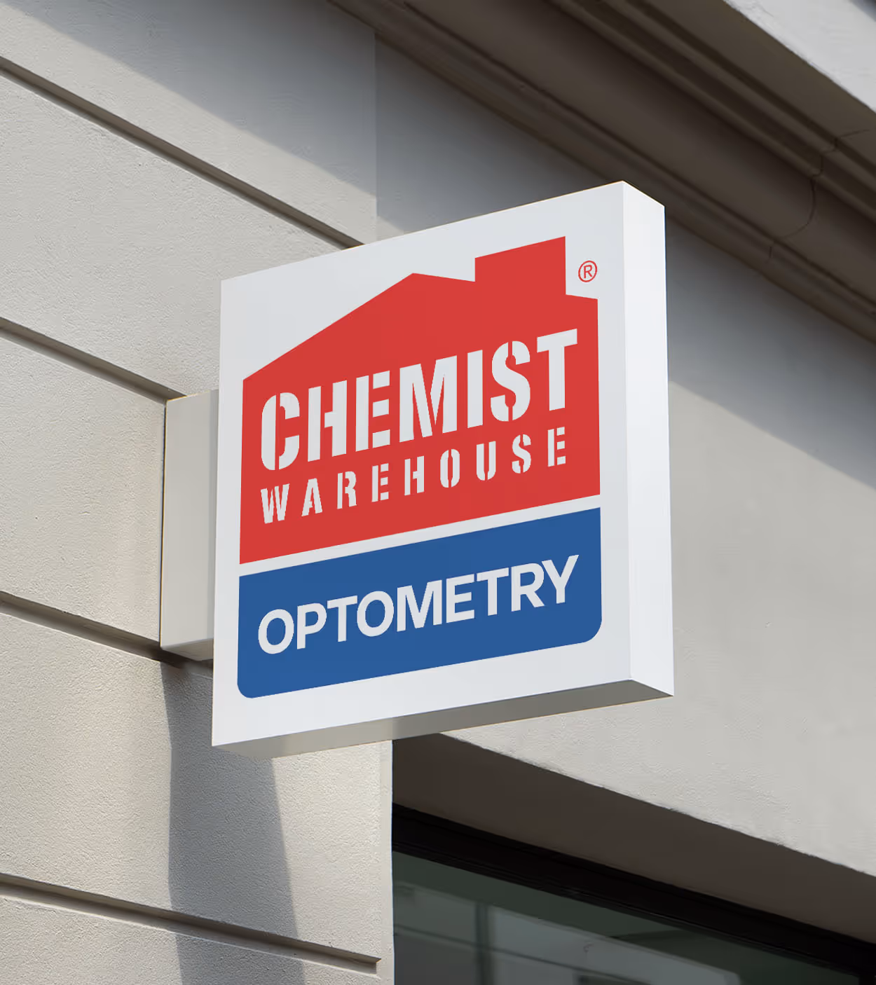 Wall-mounted sign for Chemist Warehouse Optometry with red and blue text blocks.