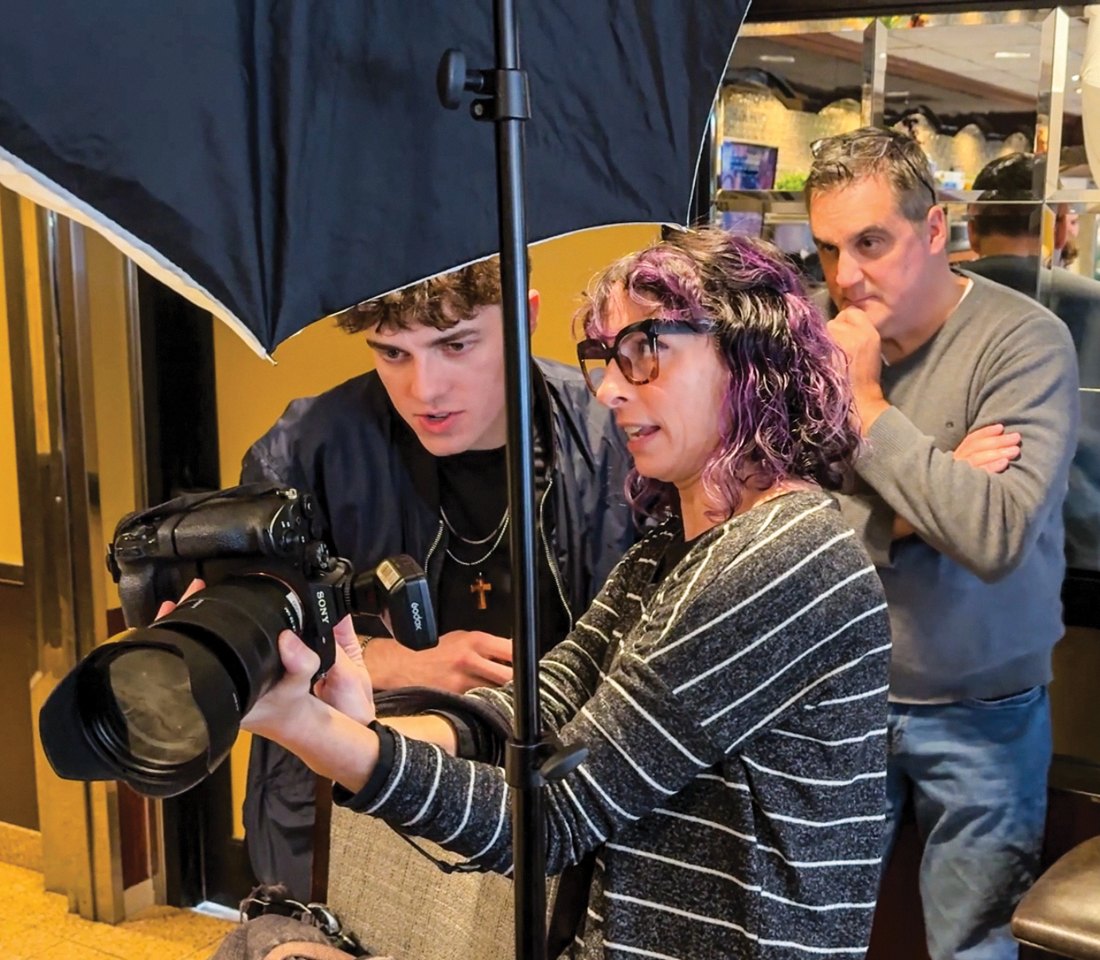 Evan Cronin, Anne-Marie Caruso and John Flynn look through photos