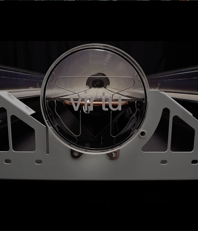 Close-up of a Solar panel tube with 'virtu' printed on it, mounted on a white mechanical frame.