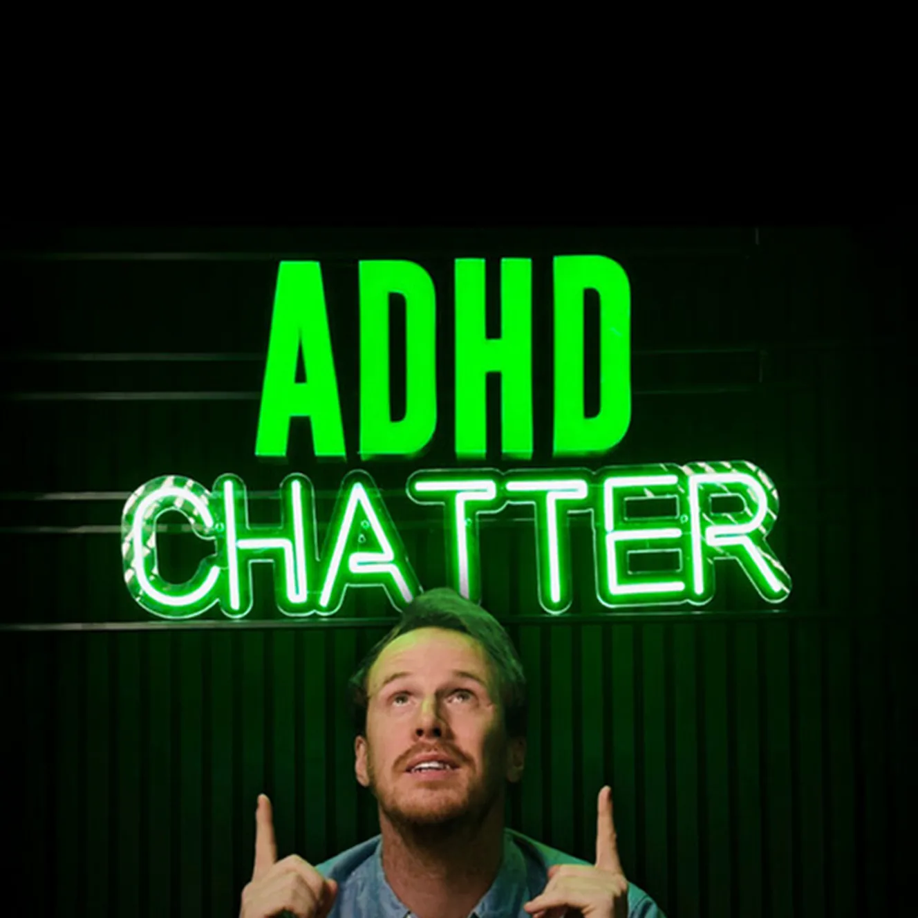Alex Partridge pointing to a neon sign of ADHD Chatter