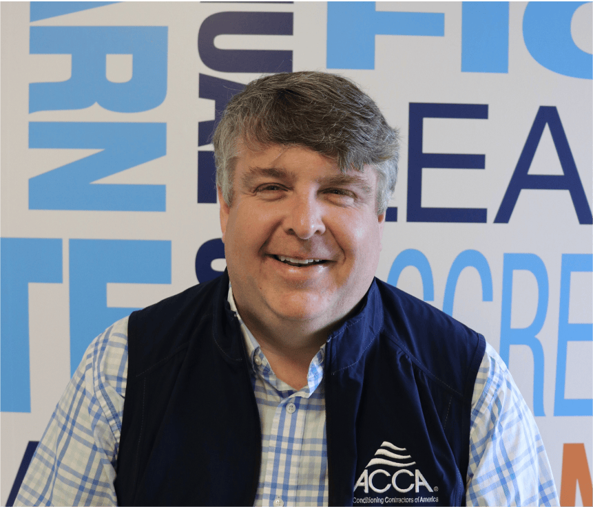 Smiling professional in blue suit representing Affiniti's leadership team