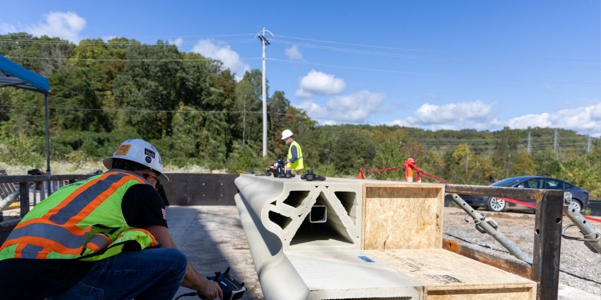 Worker prepares sinusoidal wall for assembly.