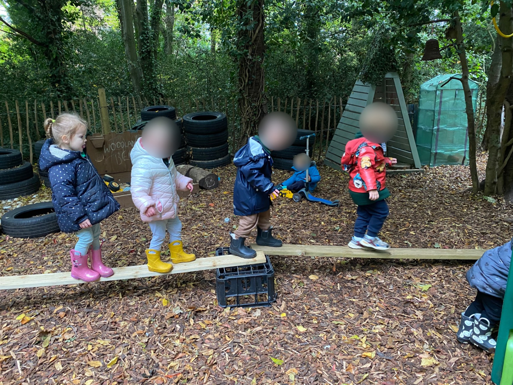 Children balancing outdoors during forest-school-inspired play