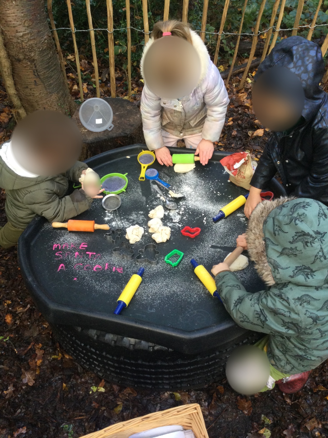 Children using play dough outdoors at Woodlands Preschool Hemel