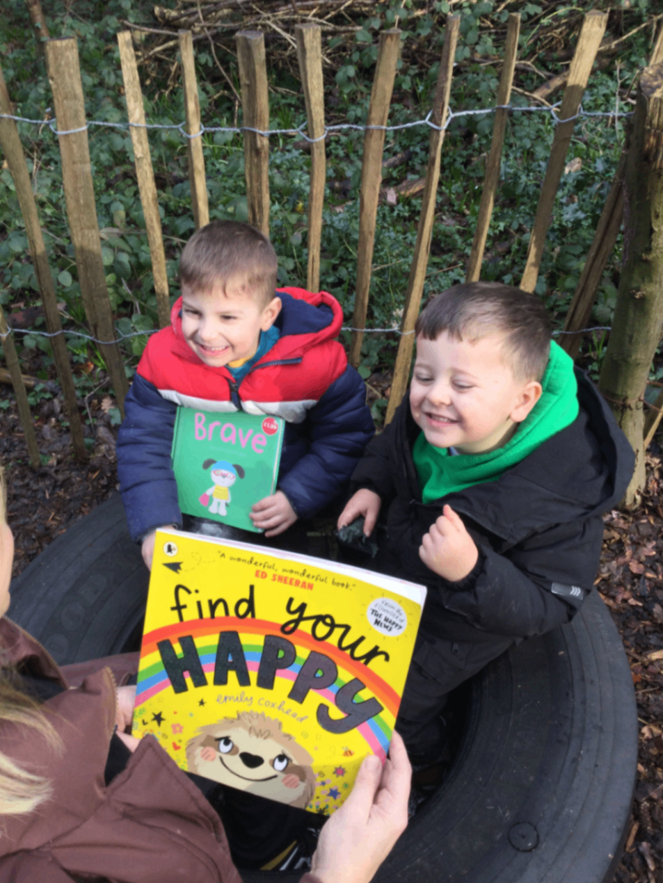 Two preschool children enjoying outdoor reading time