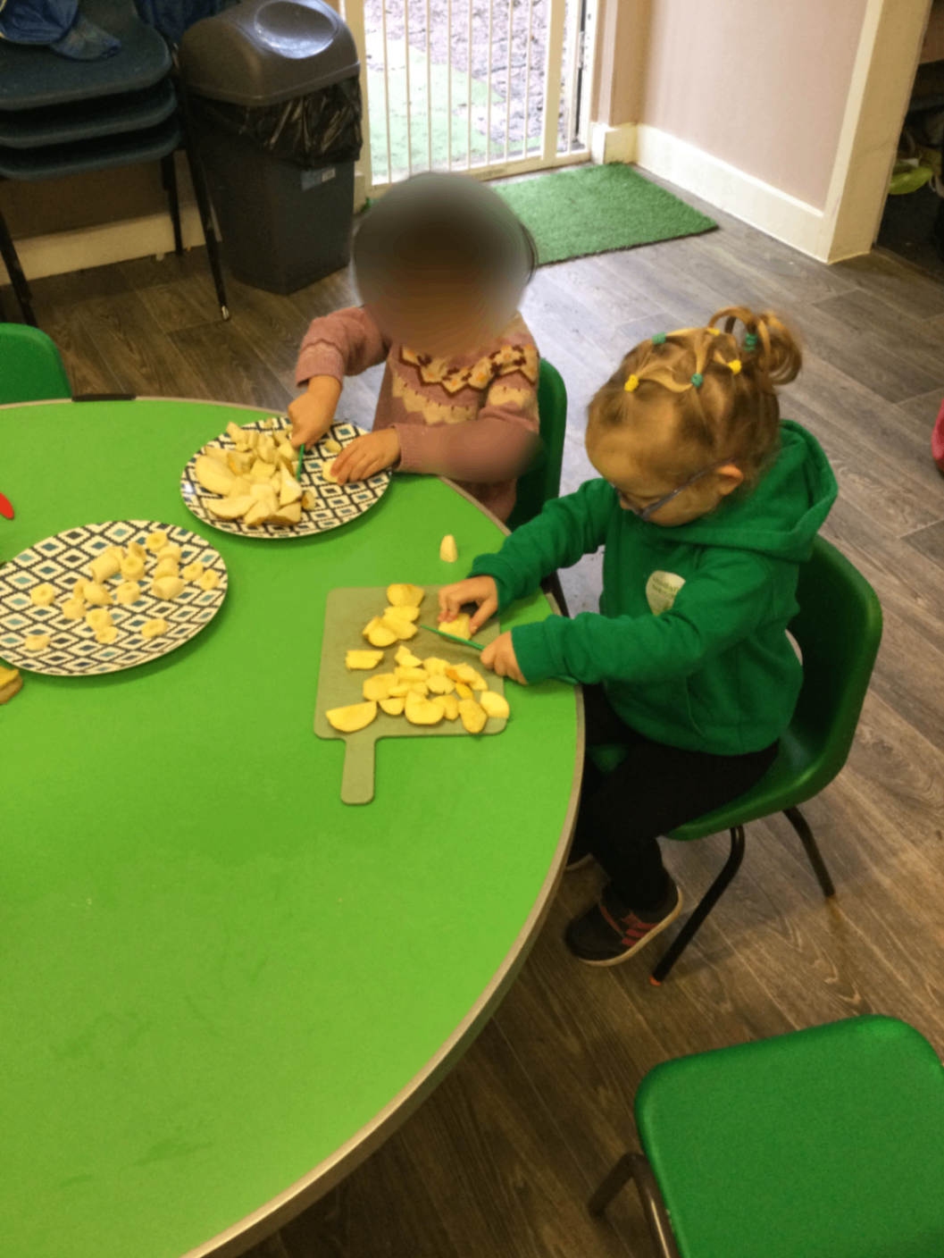 Children preparing apples together – building independence and practical life skills