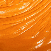 Smooth, creamy orange sauce with a glossy texture.