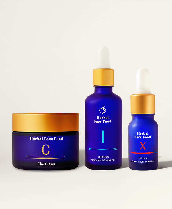 Blue jar of Herbal Face Food C cream with a gold lid on a beige background.