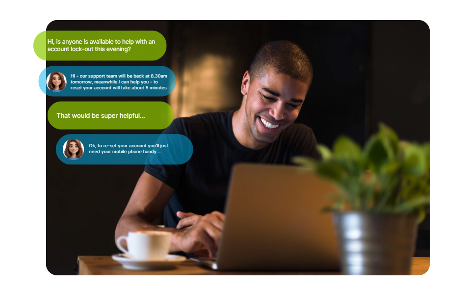 Smiling man sitting at a table with a laptop and cup of coffee, engaged in a chat conversation about account lock-out support.