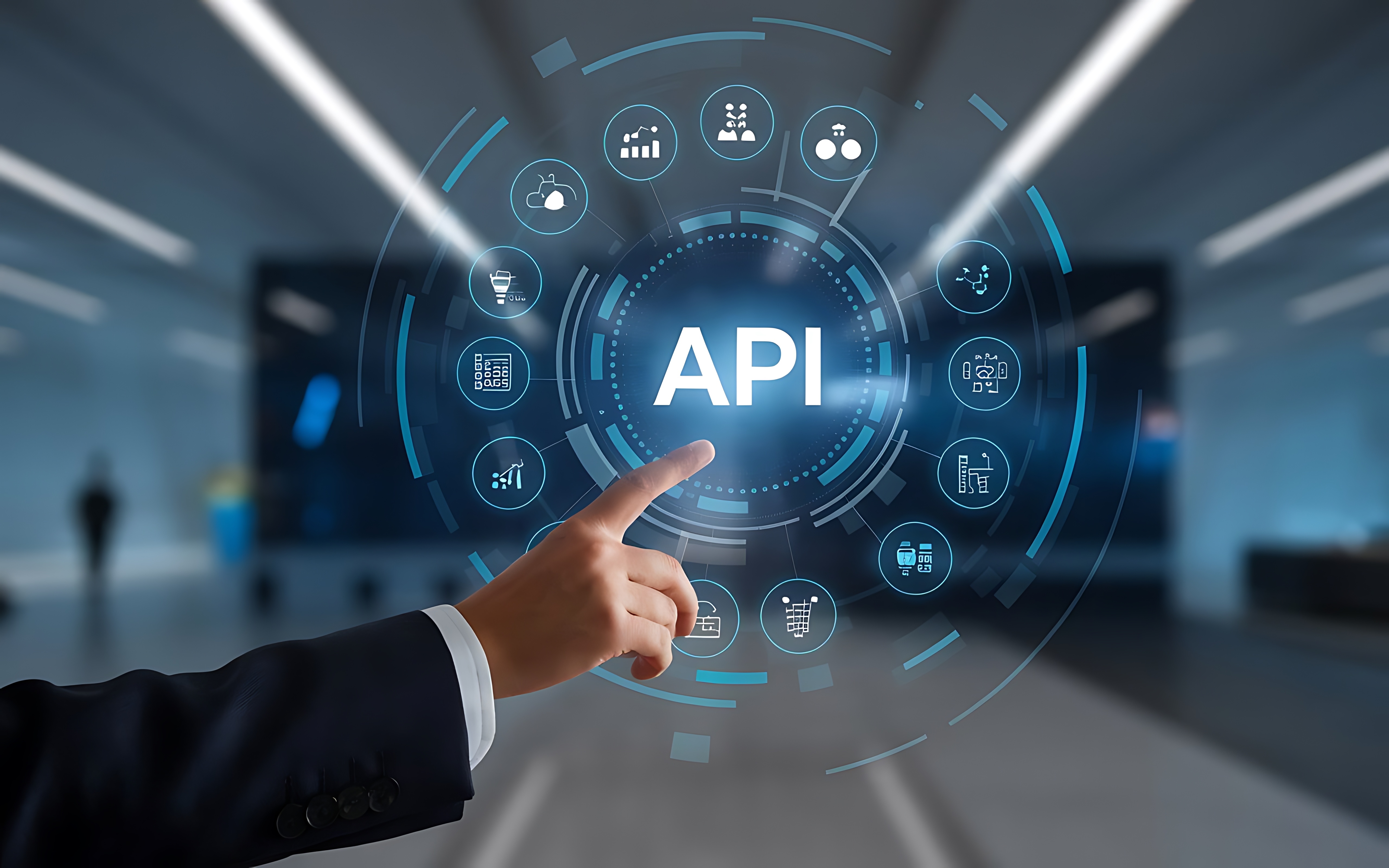 Businessman in a suit pointing at a glowing digital interface showing the word API surrounded by technology icons in an office setting.