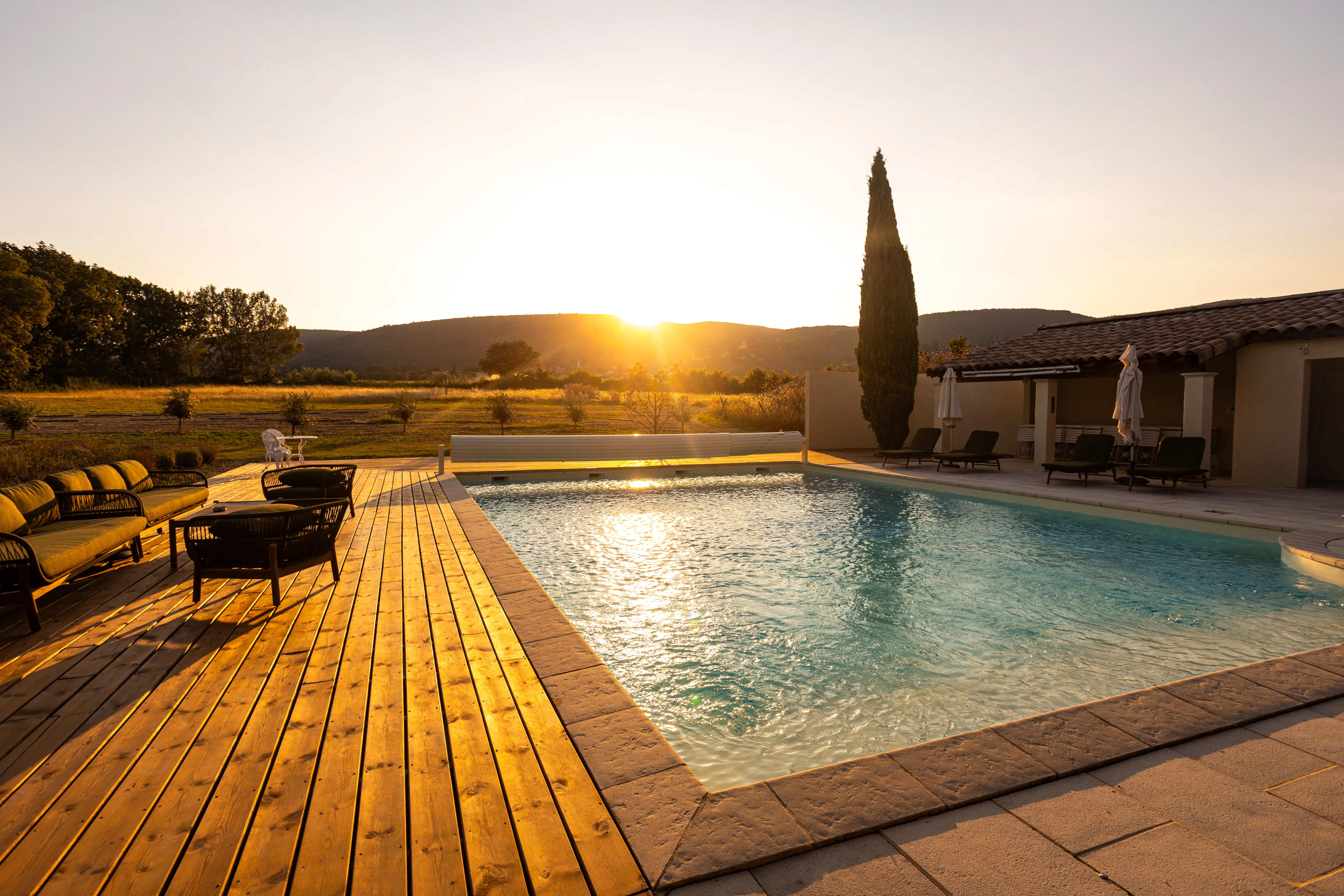 Domaine de la Vivande swimming pool, a peaceful haven nestled in nature, surrounded by lavender, olive trees, and golden light