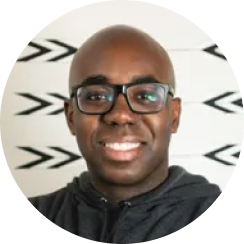 A man wearing glasses and a black jacket.